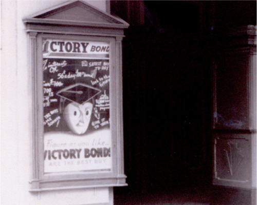 A black and white photograph of a poster outside of the Grand Theatre.