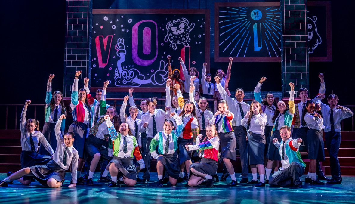 The cast of the Matilda together on stage during a performance.