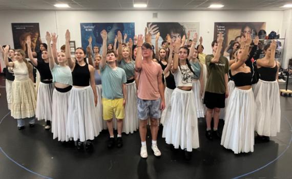 Cast of The Phantom of the Opera perform in the rehearsal hall.