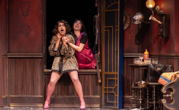 Annie attacks Sandra from behind, through a window.