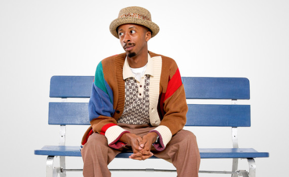 Durae McFarlane as Kenneth, sitting on a bench.