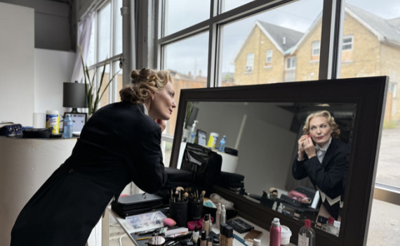 Terra C. MacLeod adds finishing touches, getting dressed to become Marlene Dietrich.