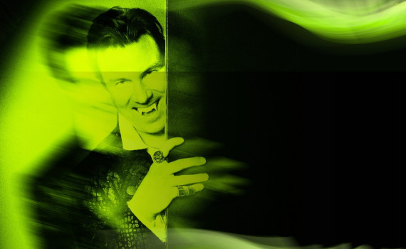 Dracula appears from behind a door, out of focus, in a vibrant black and lime green.