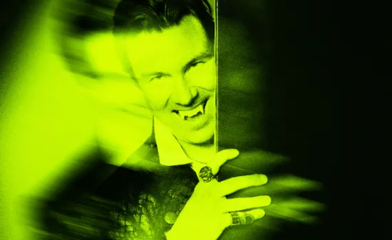 Dracula peers around a dark door, lit in neon green.