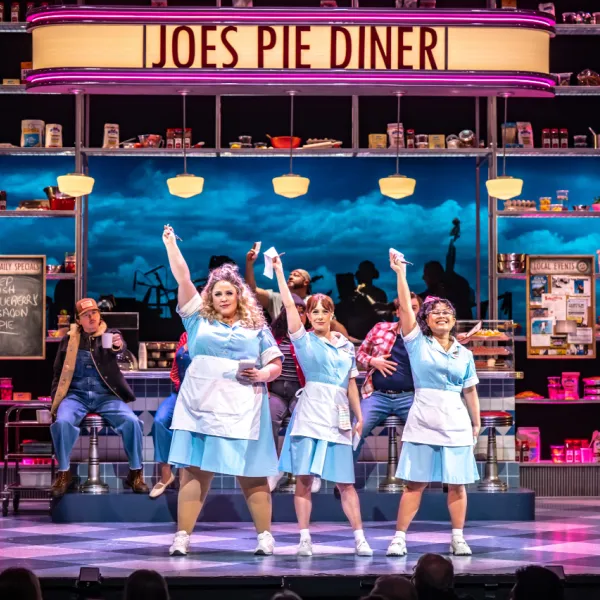 Pictured: THE COMPANY OF WAITRESS. Director: Rachel Peake. Music Director: Patrick Bowman. Choreographer: Genny Sermonia. Set & Costume Designer: Scott Penner. Lighting Designer: Michelle Ramsay. Sound Designer: Richard Feren. Fight & Intimacy Director: Siobhan Richardson. Photo by Dahlia Katz.