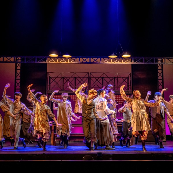 Pictured: Company members of Disney’s NEWSIES at the Grand Theatre. Directed by Ray Hogg. Music Direction by Matthew Atkins. Choreographed by Krista Leis. Set Design Consultant: Joshua Quinlan. Costume Design by Lisa Wright. Lighting Design by Echo Zhou周芷會. Sound Design by Emily Porter. Fight Director: Mike Dufays. Disability Consultant: Kristi Hansen. Stage Management by Melissa Cameron. Photography by Dahlia Katz.