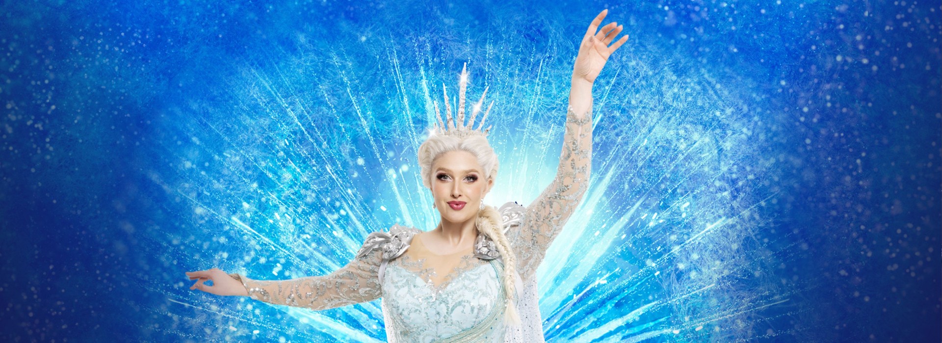 Elsa seen poised with magical power, wearing a beautiful gown.