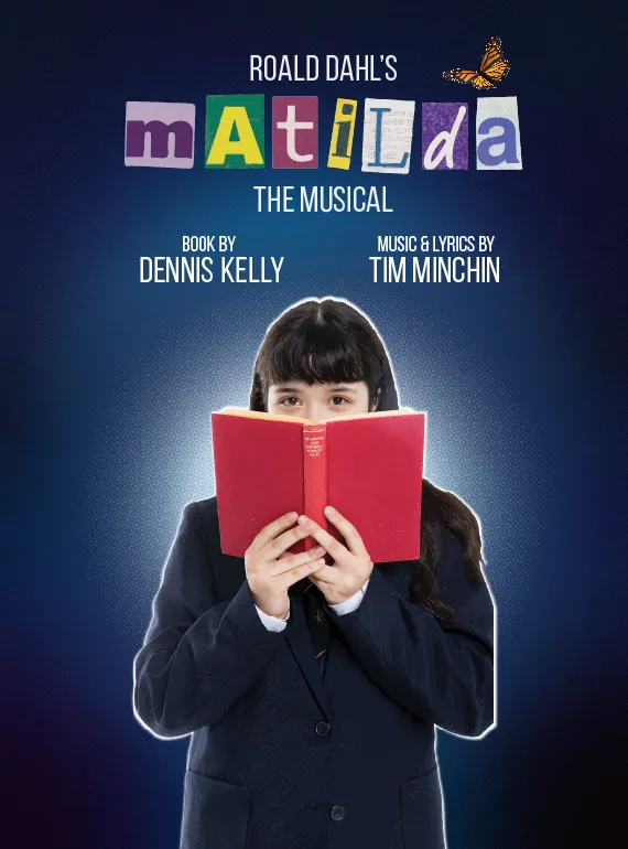 A girl wearing a school uniform holds an open book, obscuring her face.